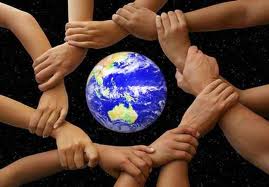 Group of people holding hands with the earth in the middle