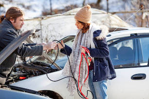 A friendly stranger helping to jump start a car